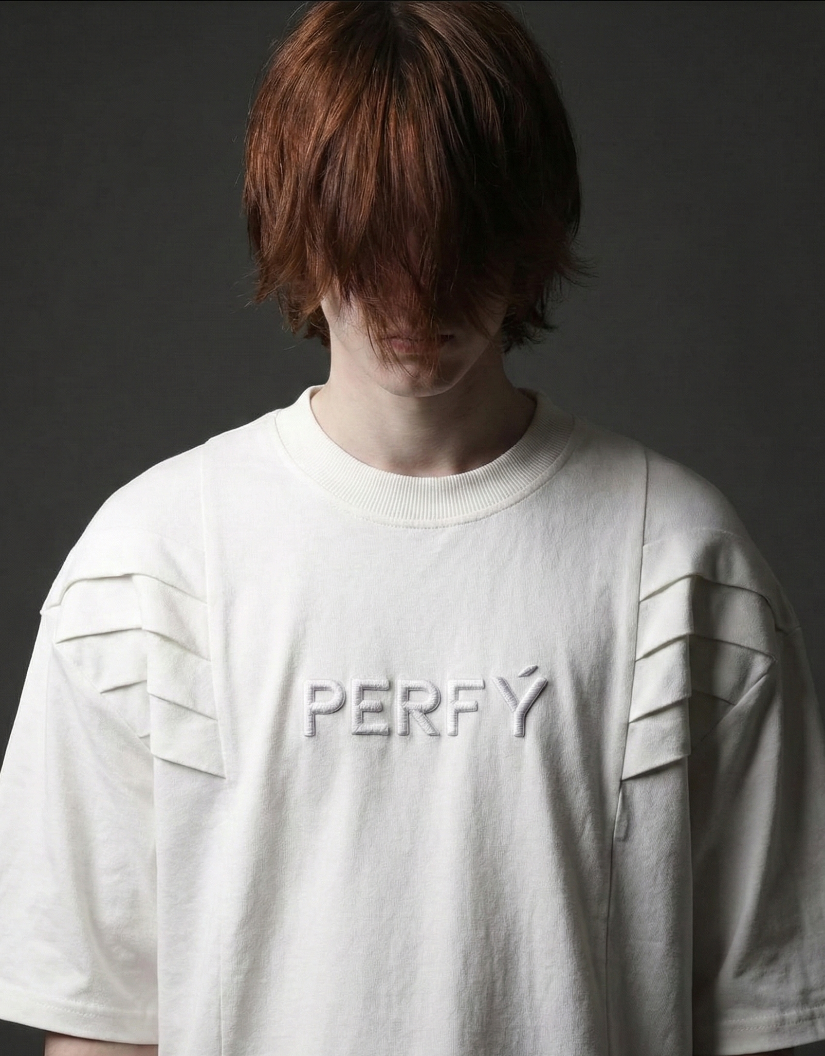 Person wearing a white t-shirt with 'PERFY' branding against a dark background